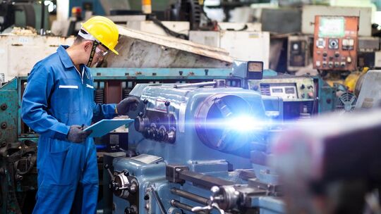 Mechanical Engineering control lathe machine in factory facility. Safety First at work place. Mechanical Engineering control lathe machine in factory facility. Safety First at work place.